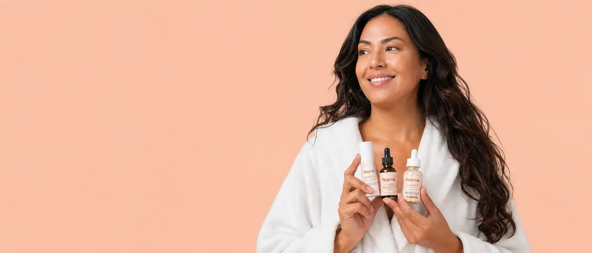 Marné campaign portrait of a woman holding the Peptide Eye Gel-Cream, Vitamin C Brightening Serum and Dark Spot Serum
